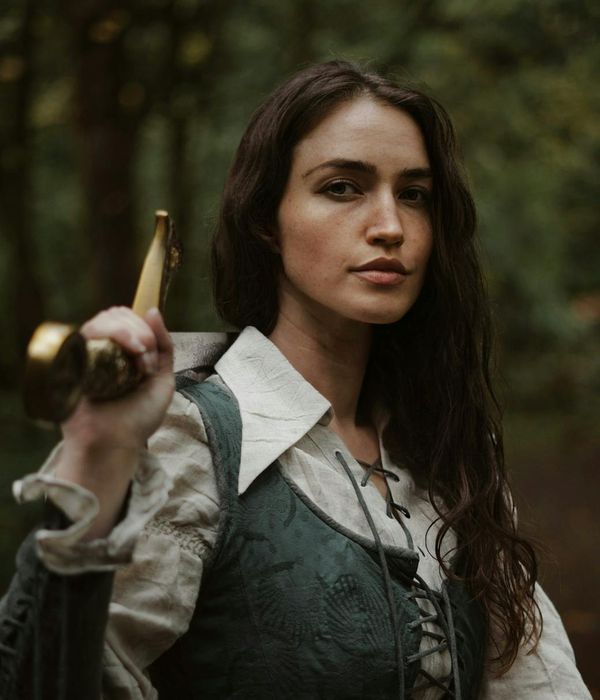 A person performing a warrior yoga pose with confidence and strength.