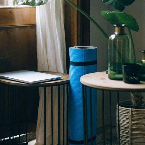 Yoga mat rolled out in a peaceful room with natural light.